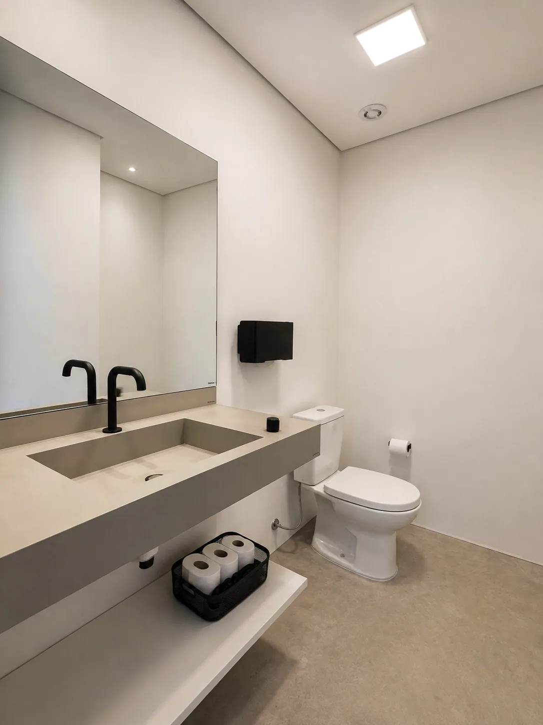 Lavabo da Kuadra com bancada de concreto e metais pretos
